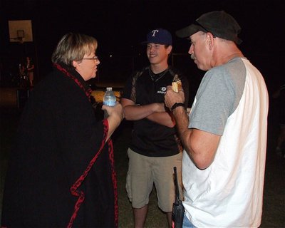 Image: Italy Neotribune’s own Anne Sutherland and her husband Tommy Sutherland, who is a volunteer fireman for the City of Italy, visit with Justin Buchanan who also volunteers time for the fire department.