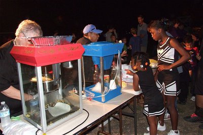 Image: IPDs Sue Lauhoff and EDC vice president Elmerine Bell work the popcorn and snow cone machines like a couple of pros.