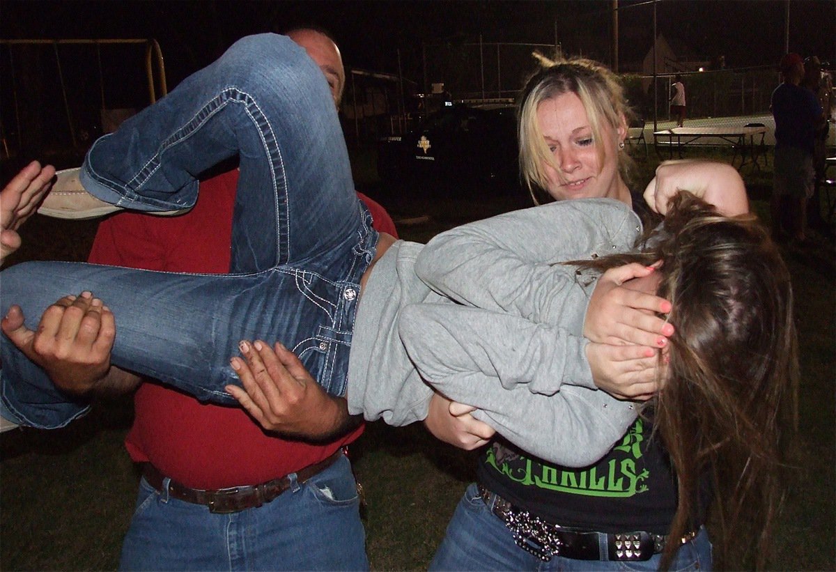 Image: Corl McCarthy is the prop during a demonstration by her friends and family showing how to take down an assailant that won’t pose for the Italy Neotribune camera.