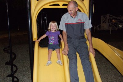 Image: Mike Britt is the greatest grandpa in the world as he slides with his granddaughter Alicia Howard during National Night Out.