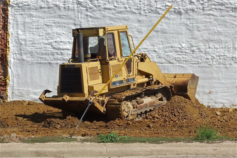 Image: A bulldozer is used to spread the sand.