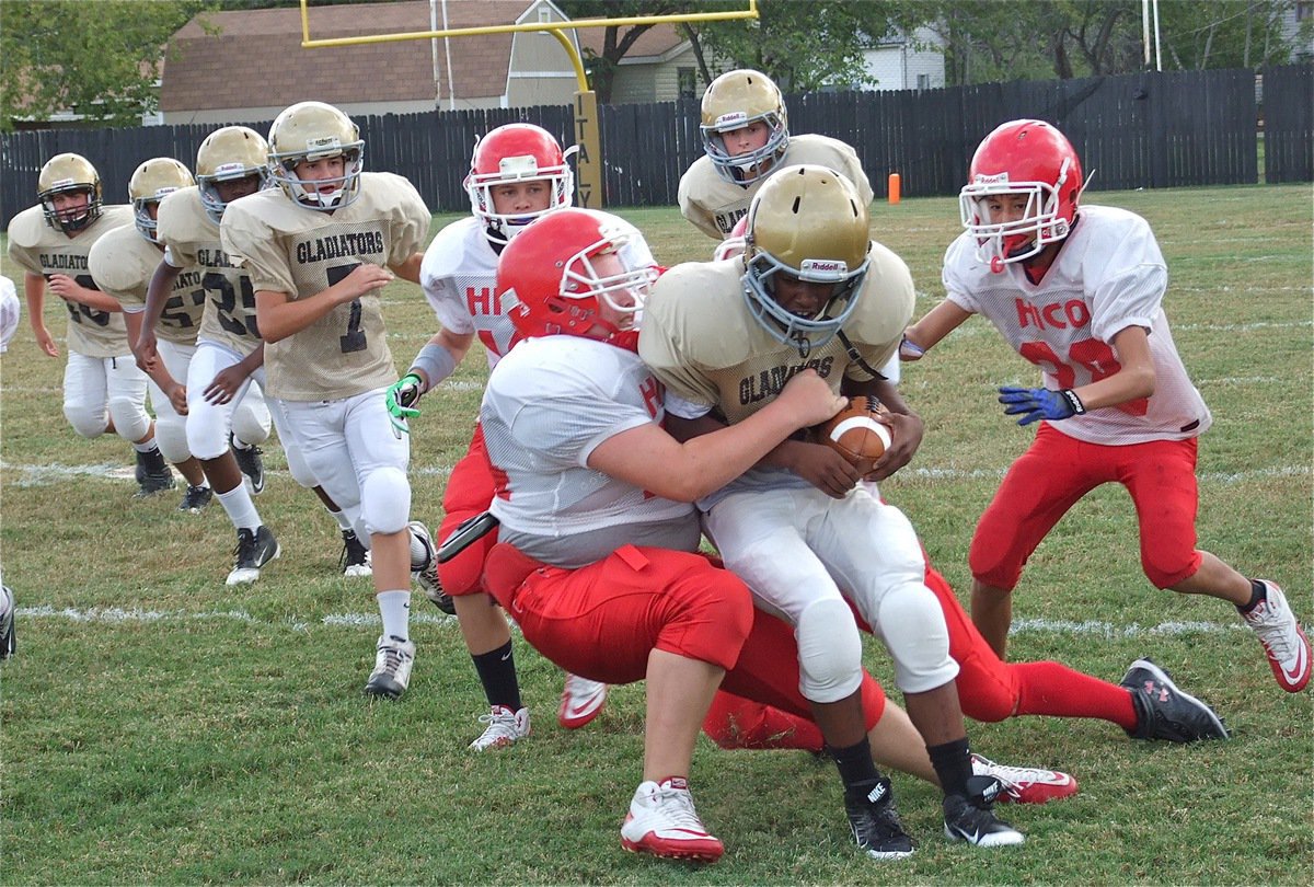 Image: 7th grade Gladiator Kendrick Norwood(20) runs hard against Hico.