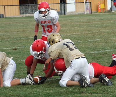 Image: 7th grade Gladiator Ty Hamilton(17) tries to recover a Tiger fumble.