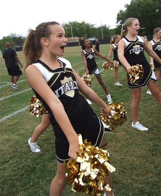 Image: Italy Junior High cheerleaders, Paige Little, Sierra Wilson and Annie Perry cheer it loud and proud along with their cheer mates.