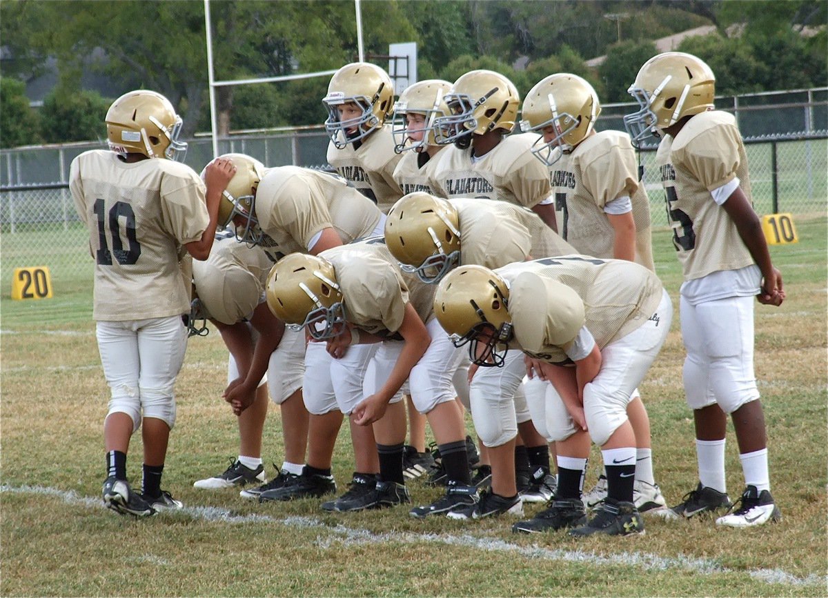 Image: 7th grade quarterback Tylan Wallace(10) relays the play to his offense.