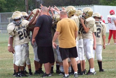 Image: Coaches Brandon Duncan and Wayne Rowe huddle the 7th graders at the conclusion of the game.