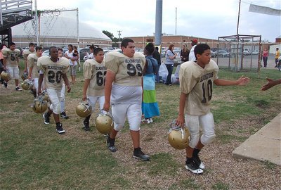 Image: The 7th grade Gladiators make their way thru proud fans on their way to the locker room.
