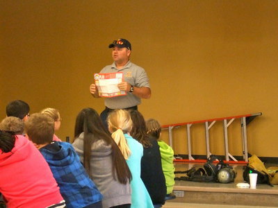 Image: Volunteer Fireman Jackie Cate tells the students to make an escape map for their homes.