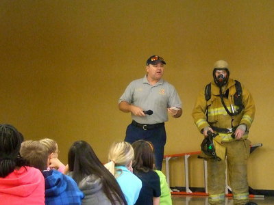 Image: Fireman Jackie Cate explaining about the bunker gear and how it protects the firemen.