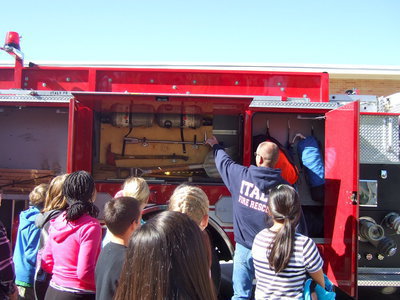 Image: Fireman Brad Chambers teaching students about the oxygen tanks.