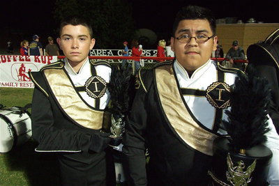 Image: Eli Garcia and Pedro Salazar stand at attention while sporting their band uniforms.