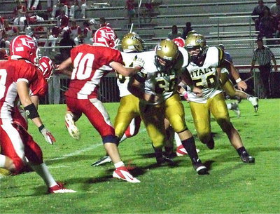 Image: Kevin Roldan(60) and Zain Byers(50) pull around center Kyle Fortenberry(66).