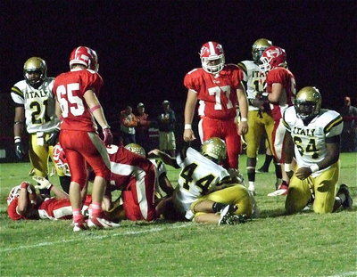 Image: Justin Wood(44), Reid Jacinto(11) and Adrian Reed(64) help bring down a Tiger runner.