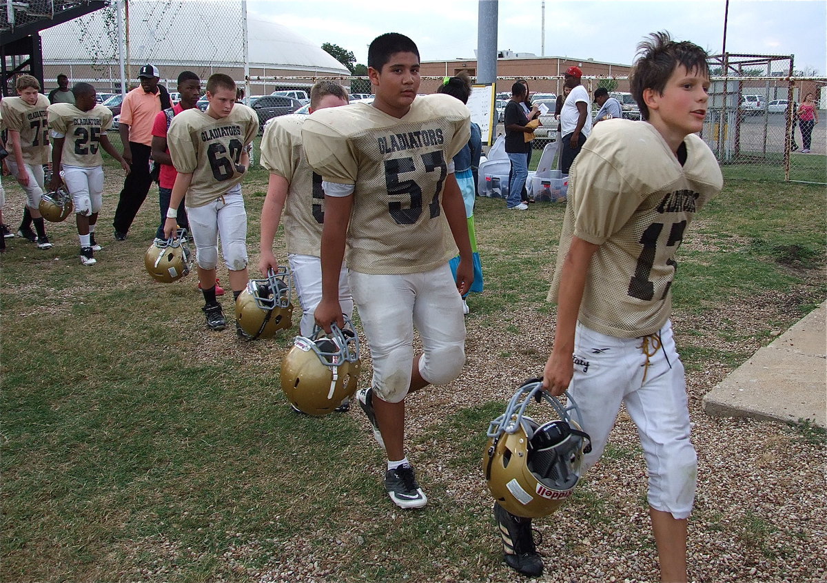 Image: Ty Hamilton(17) leads his 7th grade squad through Italy’s fans and back to the locker room.