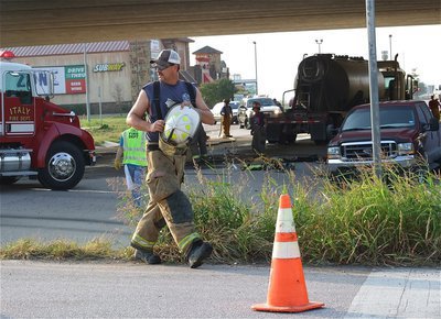 Image: Forreston volunteer firefighter Bobby McBride prepares to clear the scene of debris.