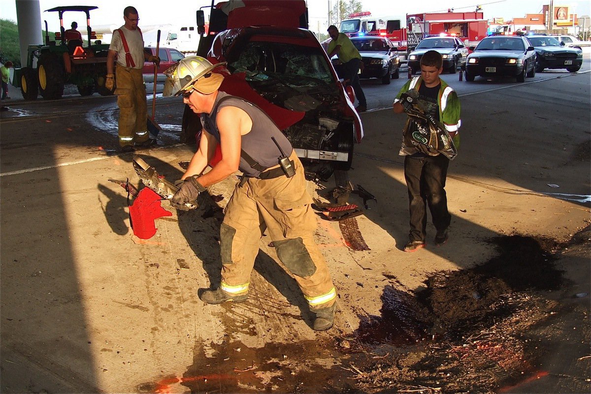 Image: Forreston firefighter Bobby McBride and Wesley Helms remove debris as Keith Helms loads the suspect’s vehicle onto the wrecker.