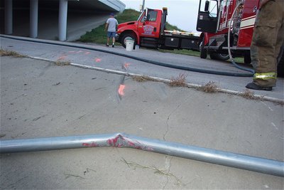 Image: Sign pole damage and scrape marks leading to the point of impact.