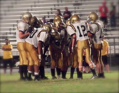 Image: Ty Windham(12) calls the play in the huddle for Italy’s JV offense.