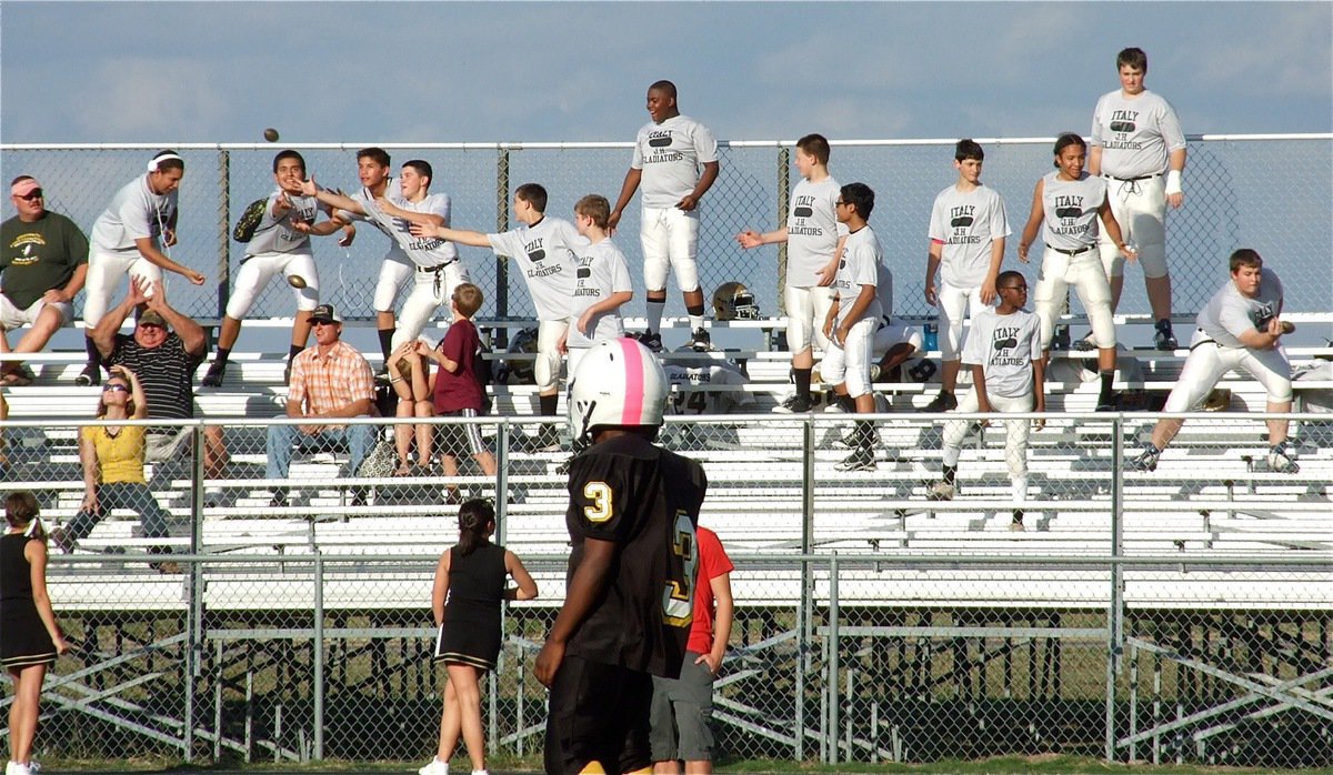 Image: Italy’s 8th grade squad collects mini footballs tossed into the stands by the cheerleaders.