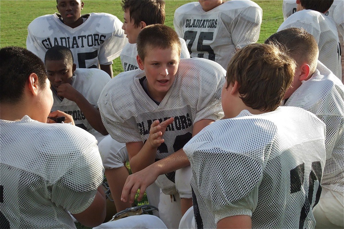 Image: Clay Riddle(60) and Cade Roberts(70) talk football during halftime.