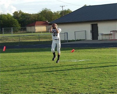 Image: 8th grade Gladiator Blake Brewer(30) catches a pass during pre-game warmups.