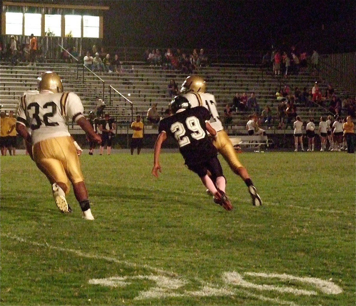 Image: JV quarterback Ryan Connor(13) eludes a Wampus Cat defender on his tail.