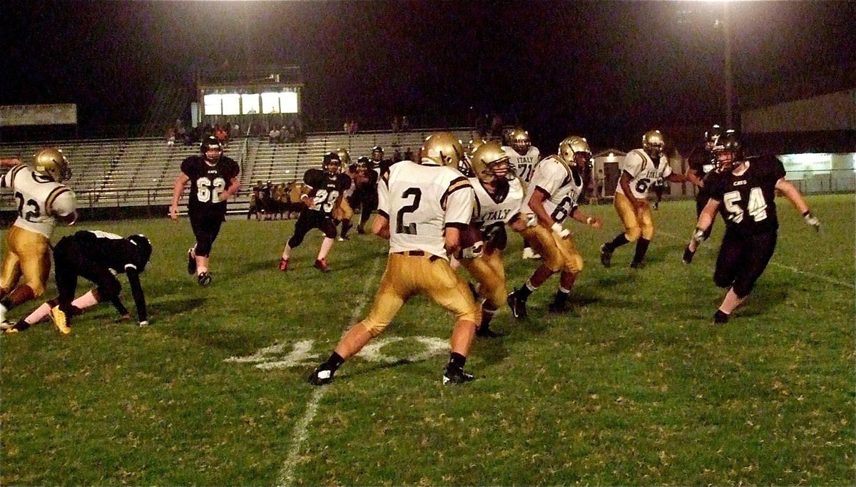 Image: Billy Moore(32), Hunter Merimon(2) and John Hughes(60) help Levi McBride(10) reach the end zone for Italy’s JV squad.