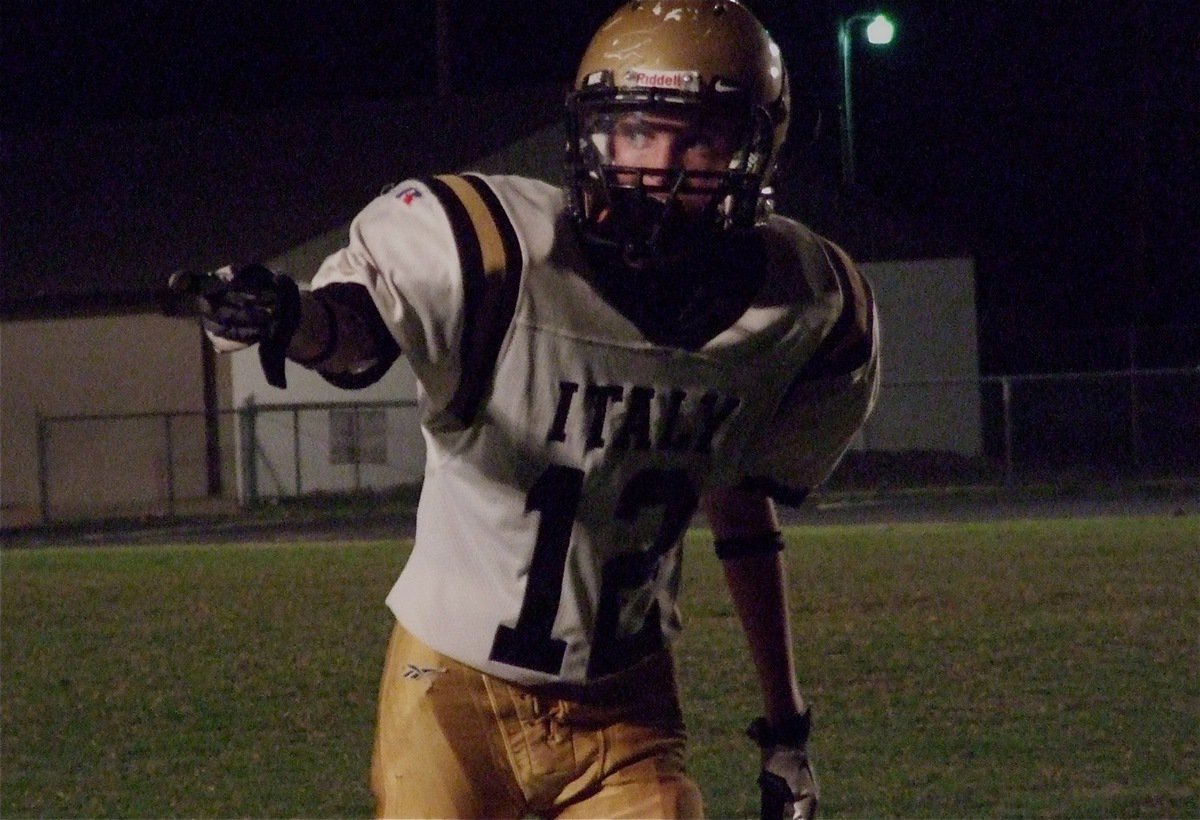 Image: JV Gladiator Ty Windham(12) checks with the sideline official before the snap of the ball.