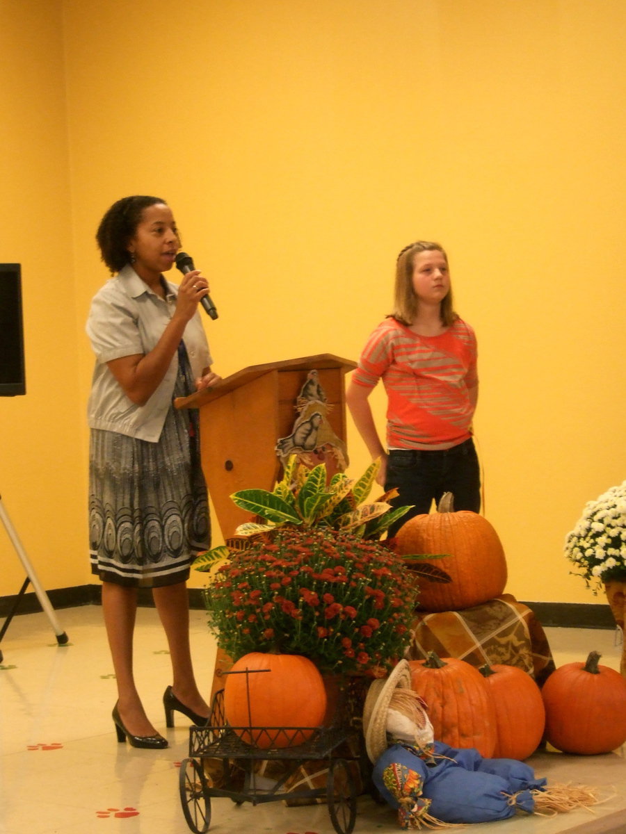 Image: Myla Wilson (principal) is welcoming the crowd and introducing Tatum Adams for singing the Star Spangled Banner.