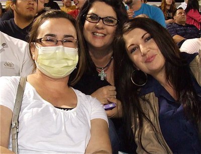 Image: Three beautiful smiles: Andrea Hooker, who recently received a heart transplant, is enjoying life with Team Hooker members Tina Long and Alexis Coots while watching the Gladiators defeat Itasca.