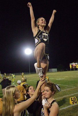 Image: Cheerleader Britney Chambers and the Gladiators were flying high against Itasca on Friday night. Fellow cheerleaders lending a hand are Kelsey Nelson, Morgan Cockerham and Taylor Turner.