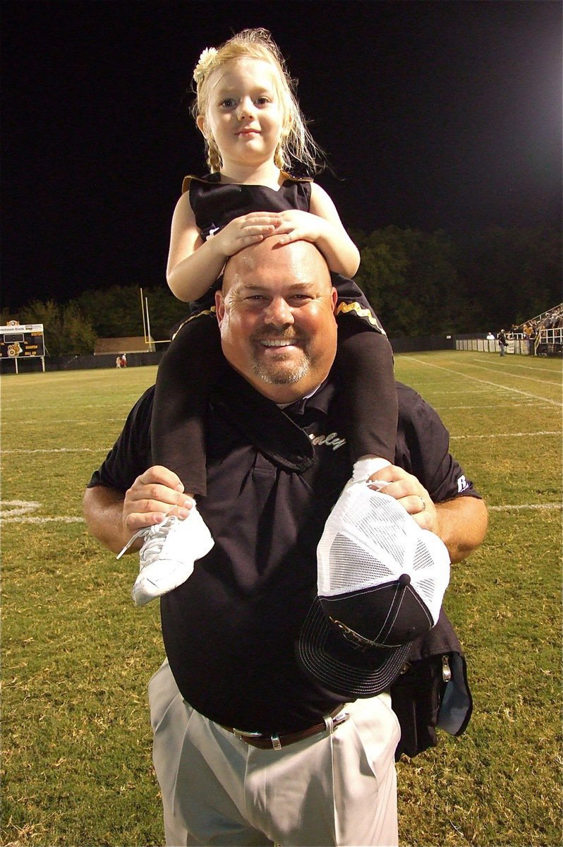 Image: Coach Wayne Rowe and his daughter Hannah take a victory walk together on Willis Field.