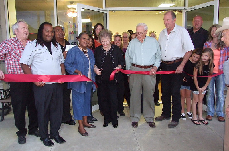 Image: Cutting the ceremonial ribbon to dedicate the new Italy Community Center. (L-R) Greg Richards, Dennis Perkins, Mayor Frank Jackson, Elmerine Bell, Manuella Barton, Joyce Hobbs (Who did the cutting honors), Terri Murdock, Sergeant Tierra Mooney, Sue Lauhoff, Clarice Crocker, Tom Little, Officer Shelbee Landon, James Hobbs and Rhonda Cockerham. Also, taking a peek on the far right are London and Haidyn.