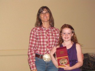 Image: Goldmyne Ranch buckle sponsor Jennifer Alexander presents Sadie Hinz of Italy, right, with the Reserve Champion 11 &amp; Under English buckle. Sadie also won the Reserve Champion 11 &amp; Under Western buckle.