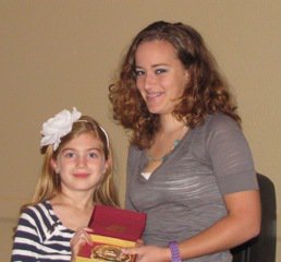 Image: ECEA Youth President Liz Terry, right, presents Autumn Wells of Waxhachie with the Nancy Jessup Youth Sportsmanship Buckle. Autumn is a student at the Flying Dollar Ranch in Italy.
