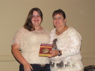 Image: ECEA Vice President Becky Hansen, left, presents Alyssa Ballew of Midlothian with the Walk Trot Champion buckle. Alyssa is a student at the Flying Dollar Ranch in Italy.