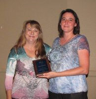Image: ECEA board member Cyndy Gamster, left, presents Mary Roberts of Waxahachie with the Charlie Huff Hall of Fame Award.