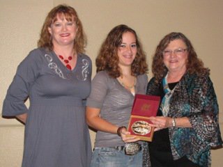Image: Flying Dollar Ranch buckle sponsors present Elizabeth Terry of Waxahachie, center, with the Reserve Champion 12 to 18 English buckle. Elizabeth also won the Reserve Champion Green Horse buckle. She is also a student at the Flying Dollar Ranch in Italy.