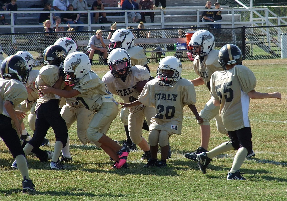Image: IYAA B-Team Gladiator Bryce DeBorde(4) looks for an opening between the Jaguars’ defensive spots.