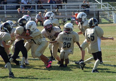 Image: IYAA B-Team Gladiator Bryce DeBorde(4) looks for an opening between the Jaguars’ defensive spots.