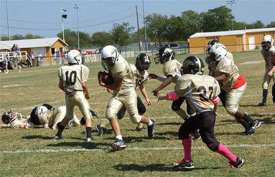 Image: IYAA A-Team’s Jonathan Salas(82) cuts thru the Hubbard defense without hesitation for the extra-point.