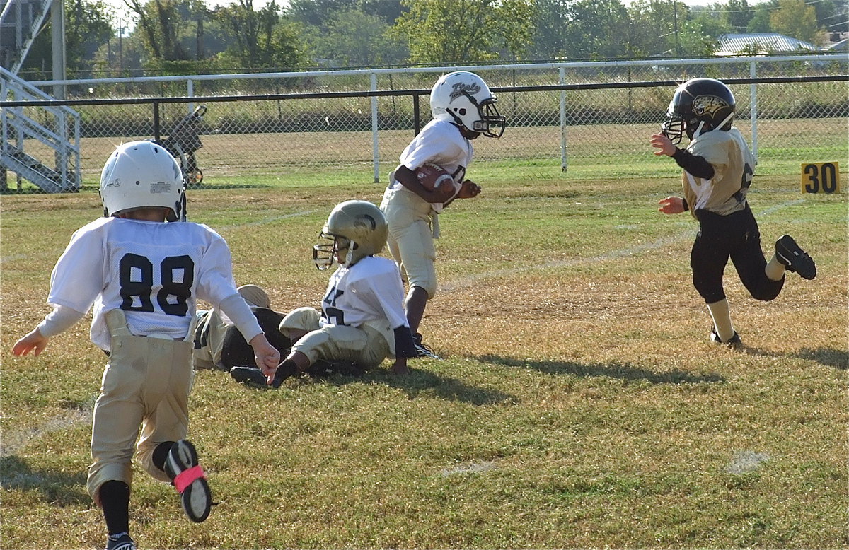 Image: Curtis Benson makes a block to spring John Hall(9) for more yards as Kevin Magness(88) hurries over to help.