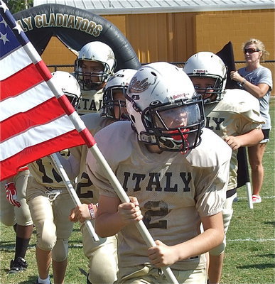 Image: Ethan Itson(2) leads his IYAA A-Team Gladiators onto Willis Field to take on Hubbard for Homecoming.