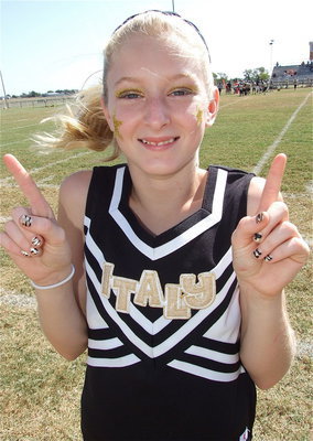 Image: A-Team cheerleader Courtney Riddle is decorated in team colors from her nails to the top of her head.