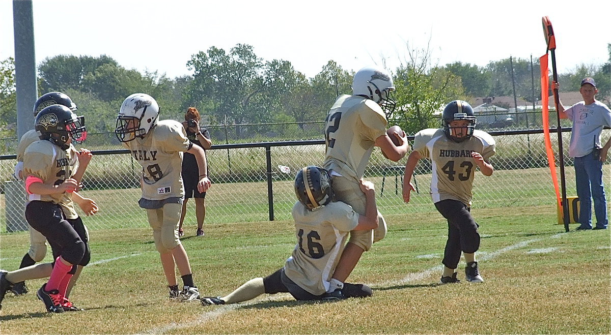 Image: IYAA A-Team Gladiator Jonathan Salas(82) pounds his way inside the 10-yard line of Hubbard.