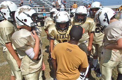 Image: A-Squad coach Jasenio Anderson talks with his team.