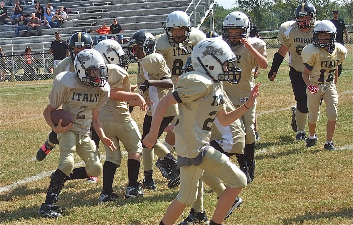 Image: Ryder Itson(2) circles around a block from Aedan Brewer(22) and then heads toward the end zone.