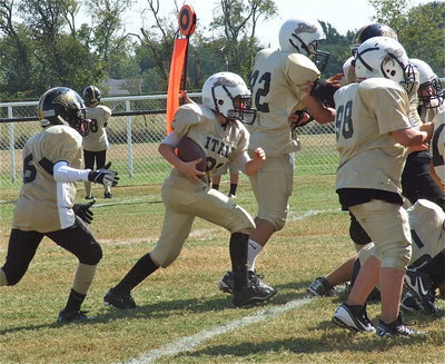 Image: A-Team Gladiator Cade Brewer(21) hits the middle of the line against Hubbard.