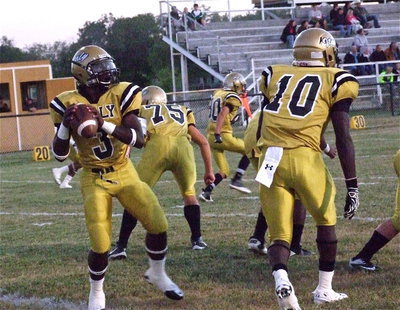 Image: Quarterback Marvin Cox(3) and Ryheem Walker(10) get warmed up for a heated contest between the Italy Gladiators and the Cross Roads Bobcats. From the pocket, Cox completed 7-of-7 for a total of 171 yards (24.4 average) for 4 touchdowns with Walker as his bodyguard.