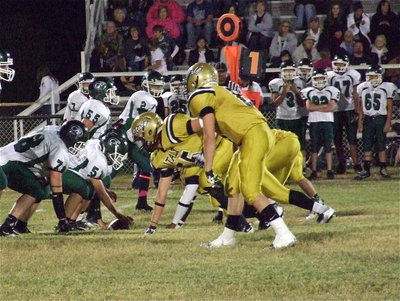 Image: Zackery Boykin(55) and Hayden Woods(8) dare Cross Roads to snap the ball. Boykin and his fellow lineman dominated the line-of-scrimmage while Woods was all over the field finishing with 14 tackles including 9 solo tackles and 1 interception.